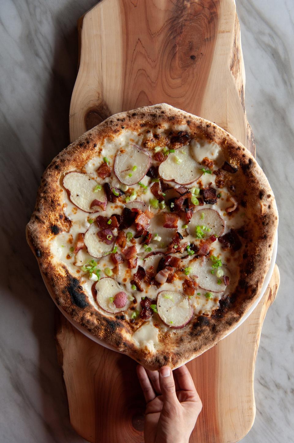 Marisol Doyle serves authentic artisan pizzas at Lena Pizza and Bagels in Cleveland.