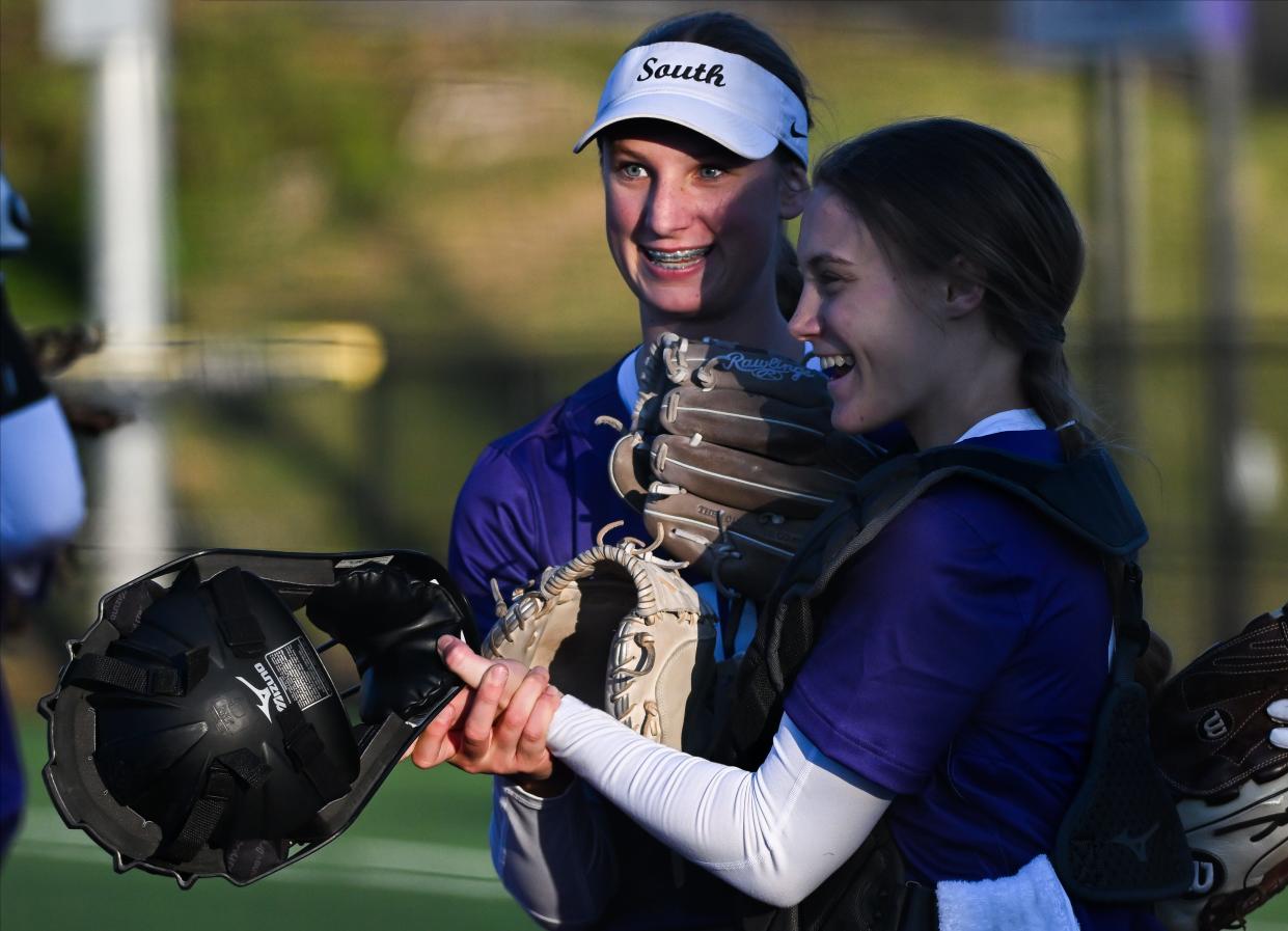 Bloomington South’s Kinsey Clopton (left) and catcher Lindsay Blanton celebrate after defeating Owen Valley at Bloomington South on Wednesday, March 27, 2024.