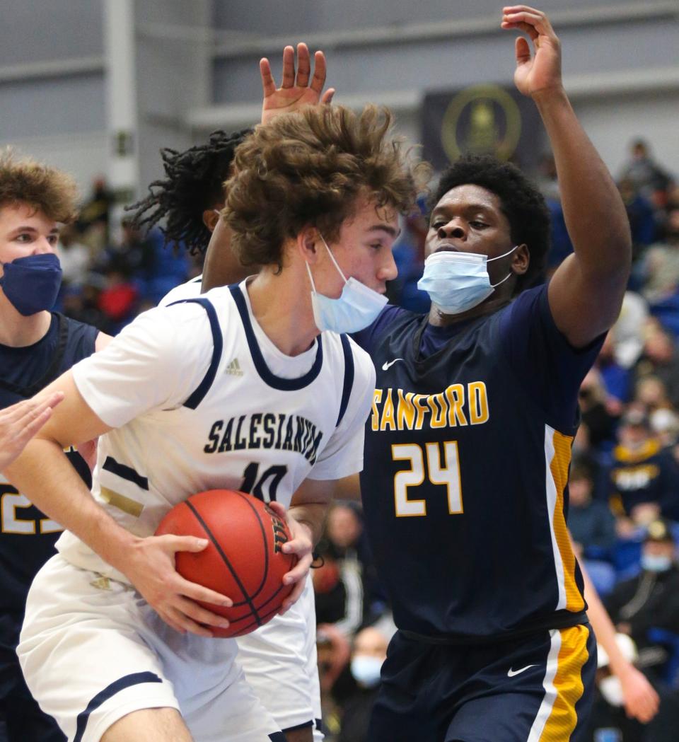 Salesianum's Justin Molen (10) tries to go the basket against Sanford's Ebuka Nwobodo in the first half of Salesianum's 55-34 win in the Unlocke the Light SL24 Memorial Classic Saturday, Feb. 5, 2022 at the Chase Fieldhouse.
