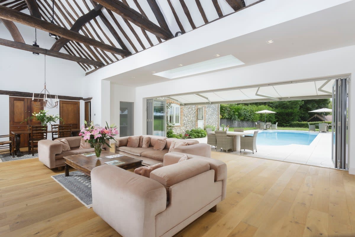The reception room in the main house leads onto the swimming pool (Savills)