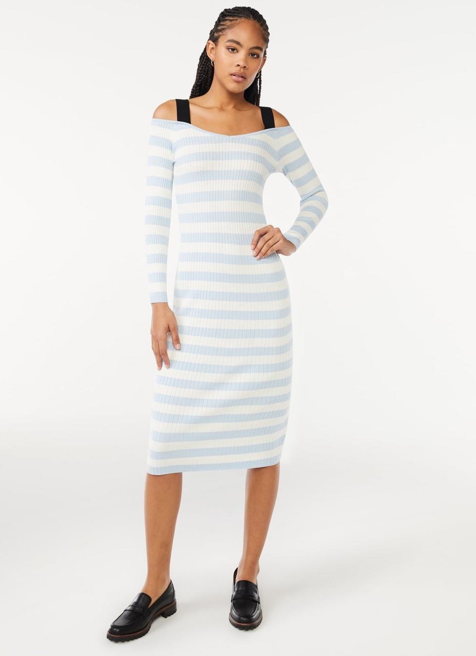 model wearing the light blue and white striped dress with black straps