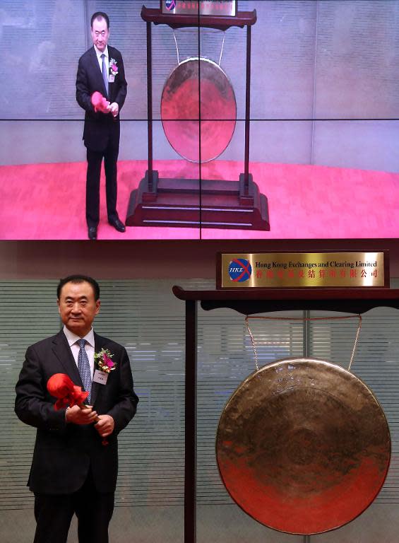 Wang Jianlin, CEO of Dalian Wanda Commercial Properties Co, opens trading during the company's IPO at the Hong Kong stock exchange on December 23, 2014