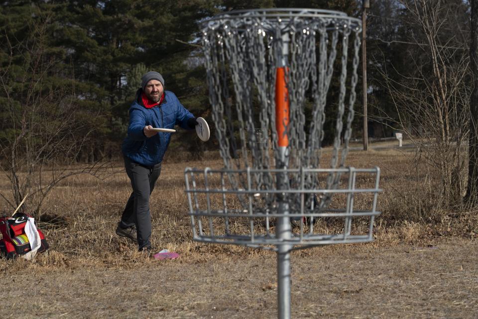 Tyler Hollinger tosses a disc in January in the men's novice round during the 31st annual Columbus Ice Bowl, a disc golf tournament at the Brent Hambrick Memorial Disc Golf Course.