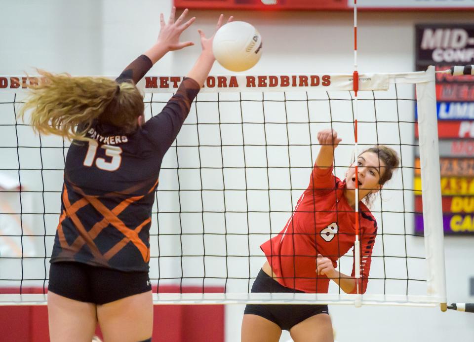 Metamora's Esma Frieden (8) goes for a kill against Washington's Jori Dowling during their Class 3A volleyball regional title game Thursday, Oct. 27, 2022 in Metamora. The Redbirds defeated the Panthers 25-12, 25-19.