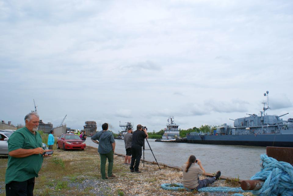 Houma residents flock to the Houma Navigational Canal to watch as the U.S.S. Kidd is towed to Thoma-Sea Marina for repairs, May 2.