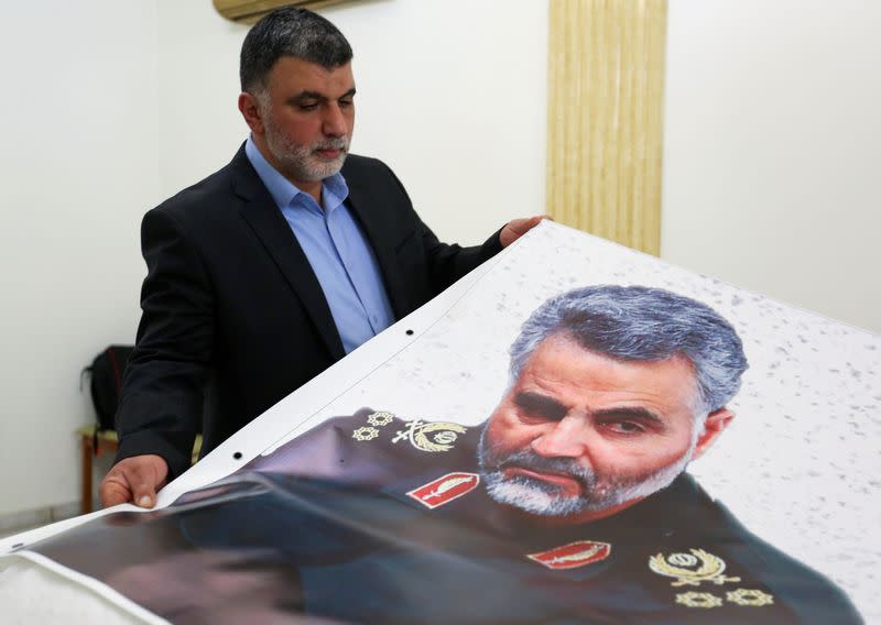 A man holds a banner depicting late Major-General Qassem Soleimani, head of the elite Quds Force, who was killed in a U.S. airstrike Near Baghdad, at the Iranian embassy in Beirut