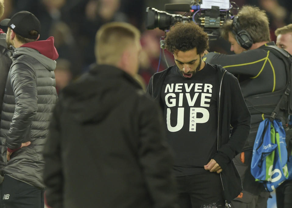 Mohamed Salah - who missed the second leg injured - wears a 'never give up' shirt