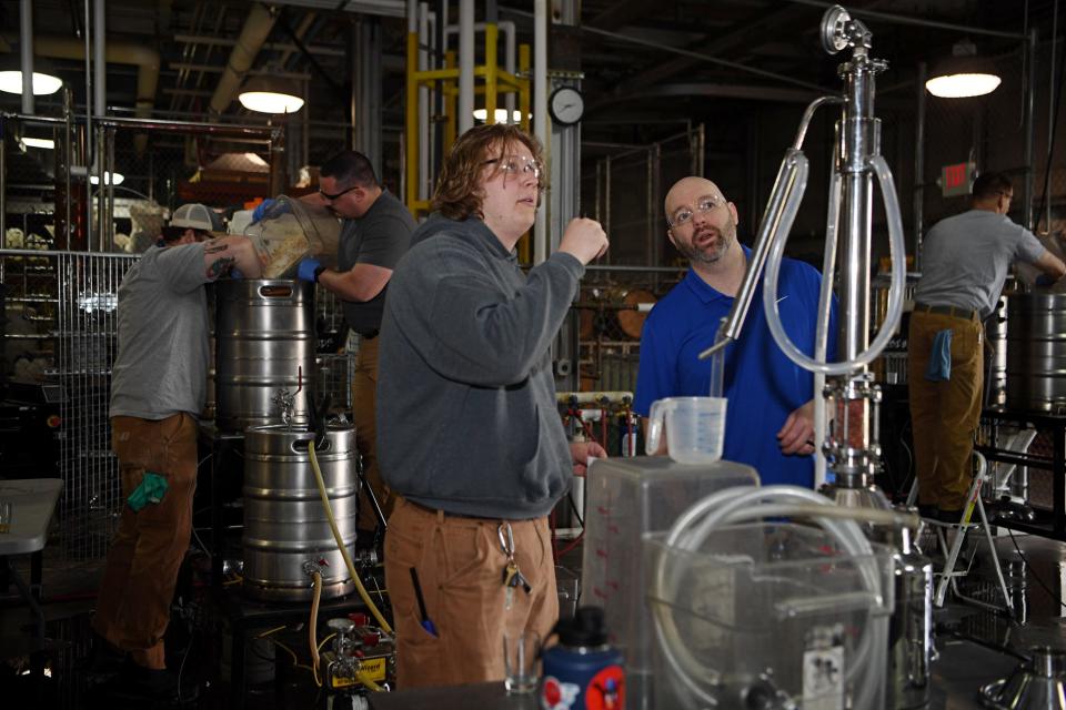 Sam Edwards, of Asheville, talks with his professor, Jeff Irvin, while working in his Brewing, Distillation, and Fermentation class at A-B Tech in Candler, March 28, 2024.