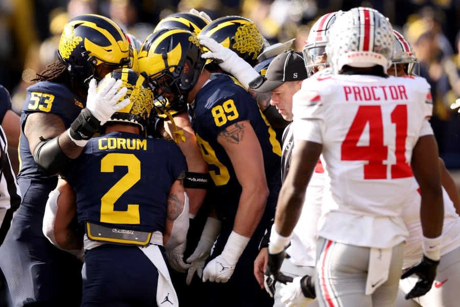 ANN ARBOR, MICHIGAN – NOVEMBER 25: Blake Corum #2 of the Michigan Wolverines celebrates with his teammates after scoring a touchdown against the Ohio State Buckeyes during the first quarter in the game at Michigan Stadium on November 25, 2023 in Ann Arbor, Michigan. (Photo by Ezra Shaw/Getty Images)