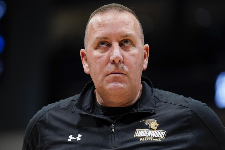 Lindenwood coach Kyle Gerdeman looks at the scoreboard during a stoppage in play in the first half of the team's NCAA college basketball game against Dayton, Monday, Nov. 7, 2022, in Dayton, Ohio. (AP Photo/Jeff Dean)