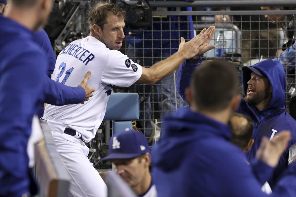 Dodgers starting pitcher Max Scherzer celebrates.