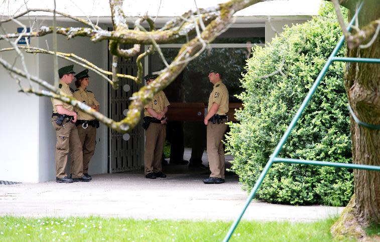 Police officers stand in front of a house where art collector Cornelius Gurlitt lived, in Munich, Germany, Tuesday, May 6, 2014. Gurlitt, a reclusive German collector whose long-secret hoard of well over 1,000 artworks triggered an international uproar over the fate of art looted by the Nazis, died Tuesday. He was 81.Photo (AP Photo/dpa, Sven Hoppe)