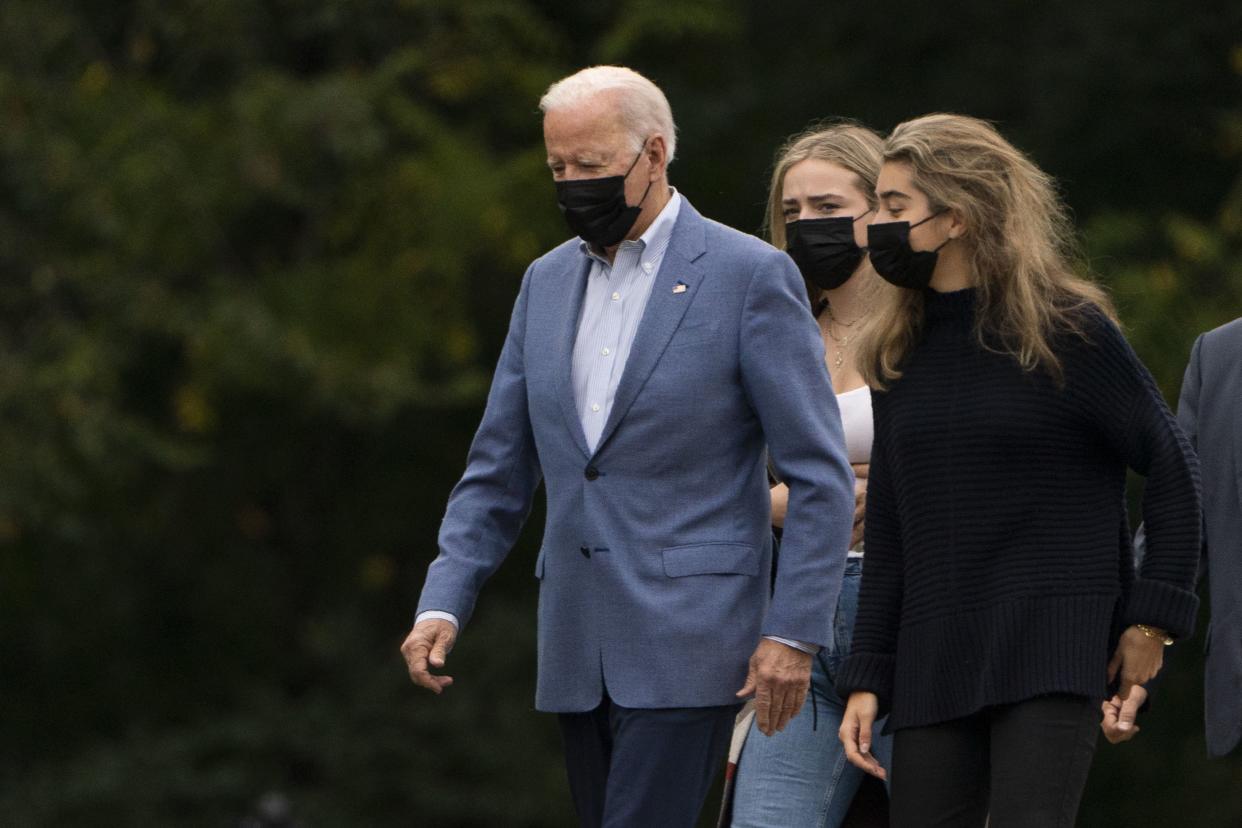 President Joe Biden arrives at St. Joseph on the Brandywine Catholic Church in Wilmington, Del., with grandchildren Finnegan Biden and Natalie Biden, right, to attend Mass, Sunday, Oct. 10, 2021.