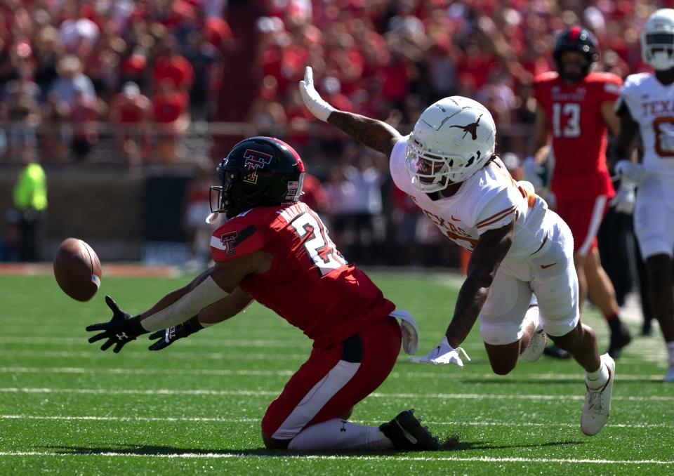 Texas Tech's wide receiver Nehemiah Martinez, left, and Texas' defensive back Jaylon Guilbeau (13) compete for a pass, Saturday, Sept. 24, 2022, at Jones AT&T Stadium.