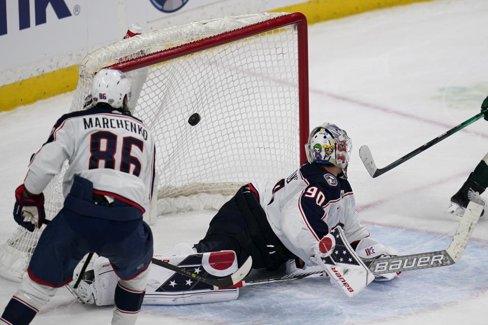 Columbus Blue Jackets goaltender Elvis Merzlikins (90), right, gives up the winning goal to Minnesota Wild left wing Kirill Kaprizov (not shown) during overtime of an NHL hockey game Sunday, Feb. 26, 2023, in St. Paul, Minn. (AP Photo/Abbie Parr)