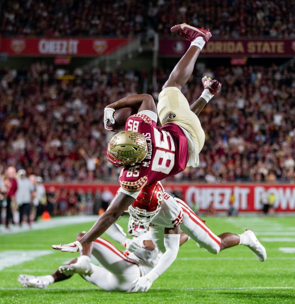 Florida State Seminoles tight end Markeston Douglas (85) soars over Oklahoma Sooners defensive back Justin Broiles (25) towards the end zone. The Florida State Seminoles defeated the Oklahoma Sooners 35-32 in the Cheez-It Bowl at Camping World Stadium on Thursday, Dec. 29, 2022.