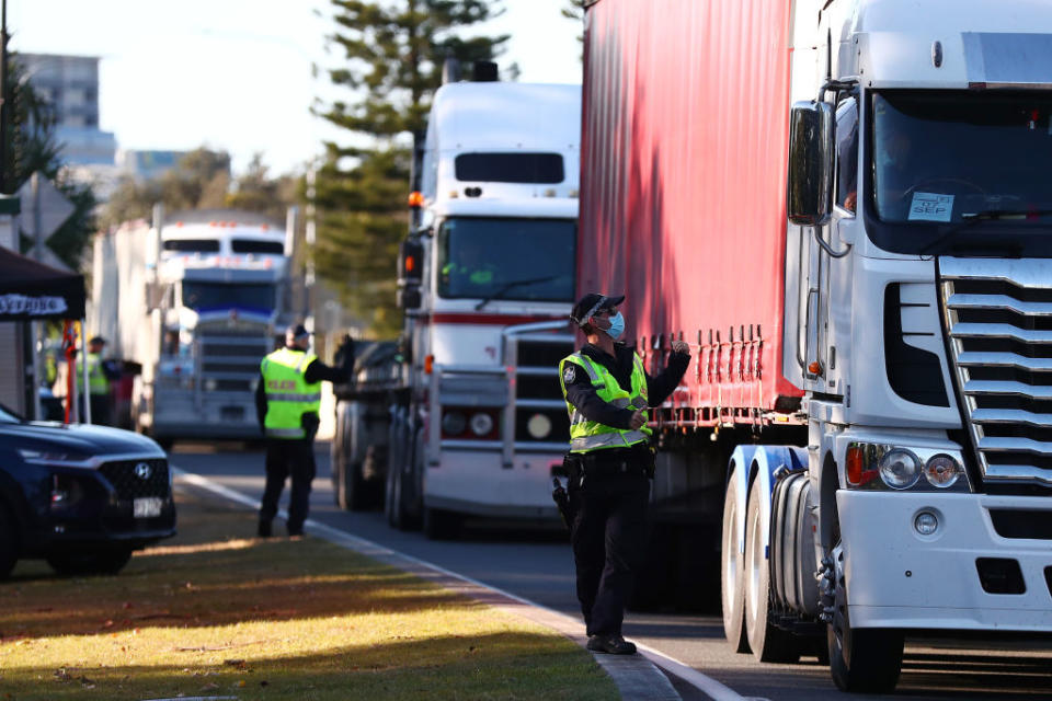 Queensland Police stop trucks at the Queensland border in Coolangatta, Australia.