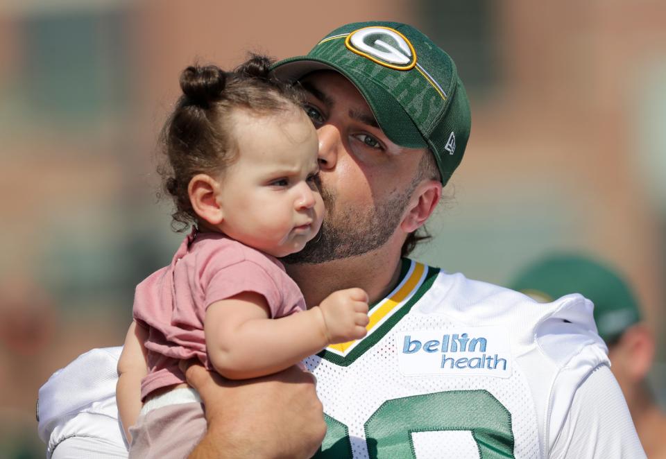 Green Bay Packers offensive tackle David Bakhtiari kisses his 7-month-old daughter, Felix, as he walks to training camp July 27 at Ray Nitschke Field.