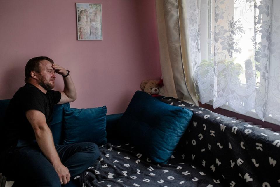 Krzysztof Sowinski sits on his couch in Dabrowa Gornicza, Poland, on July 31, where his late wife Marta rested in the days before she died. Over a year after Marta’s death, Krzysztof has not moved anything from this couch or his display of ultrasound photos and other memorabilia.<span class="copyright">Kasia Strek from TIME</span>