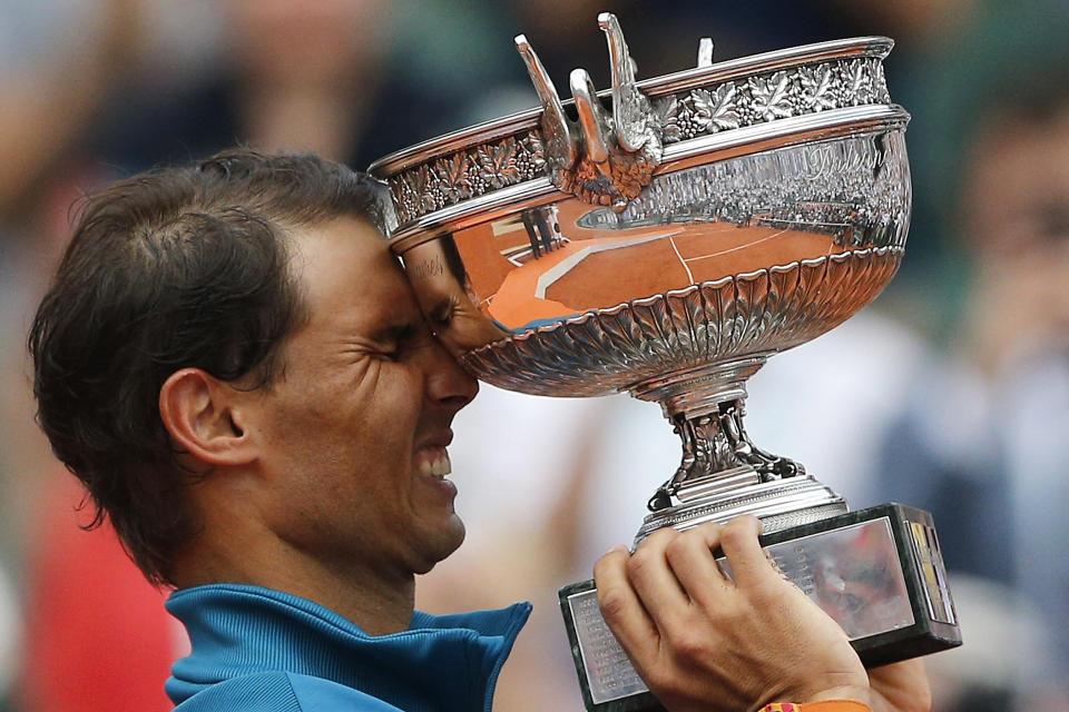 FILE - In this June 10, 2018, file photo, Spain's Rafael Nadal reacts while holding the trophy after defeating Austria's Dominic Thiem in the men's finals of the French Open tennis tournament in Paris. Nadal, a French Open champion yet again a week past his 32nd birthday seems to stay forever young. (AP Photo/Thibault Camus, File)