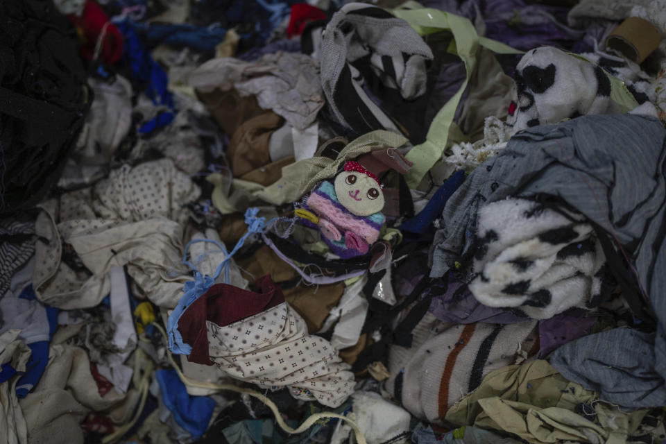 A pile of discarded textiles waits to be fed to a shredding machine at the Wenzhou Tiancheng Textile Company, one of China's largest cotton recycling plants in Wenzhou in eastern China's Zhejiang province on March 20, 2024. (AP Photo/Ng Han Guan)