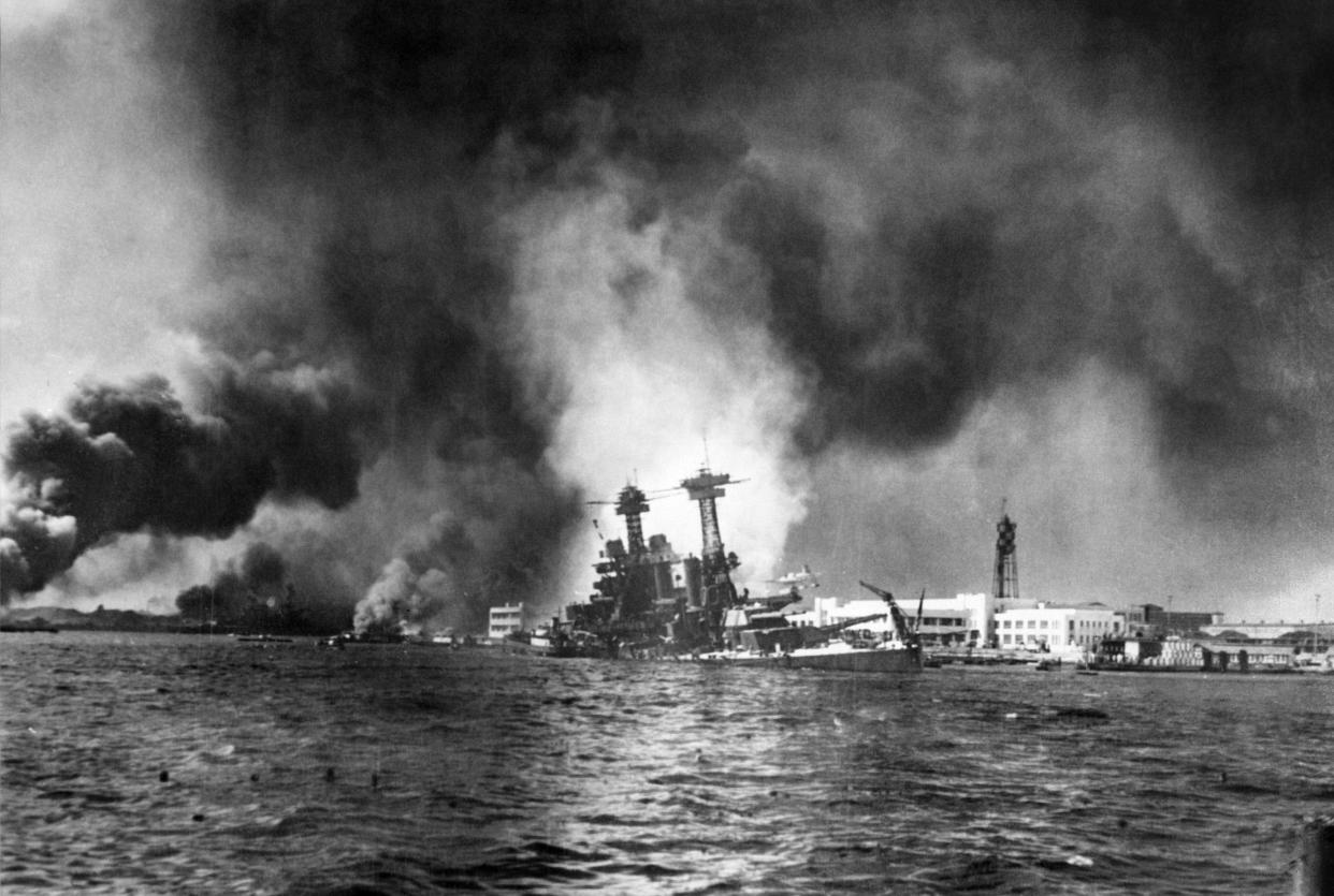 The US Pacific Fleet burns in its home base at Pearl Harbor in Hawaï after 360 Japanese warplanes made a massive surprise attack, 07 December 1941, which will end a long struggle on the part of isolationist forces in the US to stay out of the war.