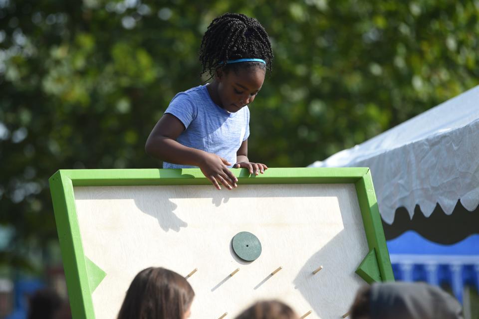 A child plays a game at Knoxville Area Urban League’s Shoes for School event in Caswell Park, Saturday, Aug. 6, 2022.