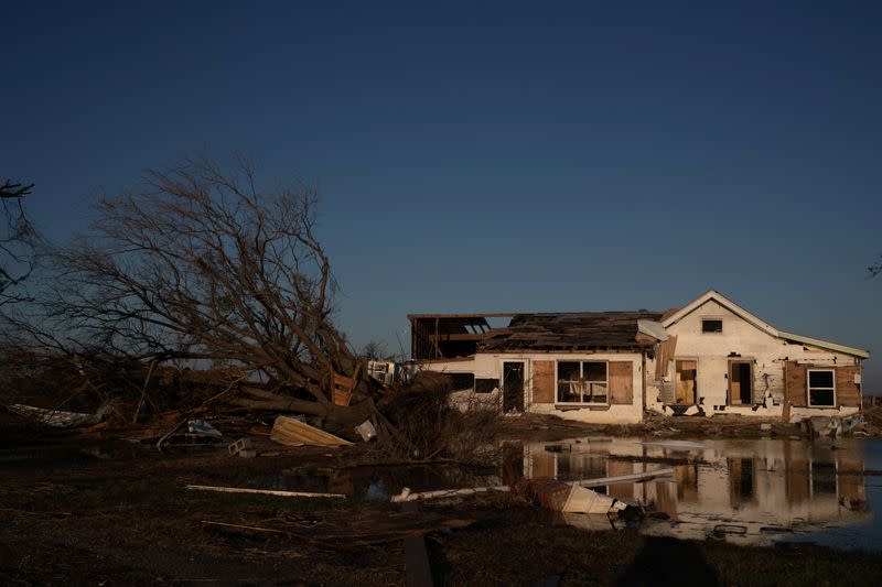 FILE PHOTO: A destroyed home is reflected in flood waters in the aftermath of Hurricane Delta in Creole, Louisiana