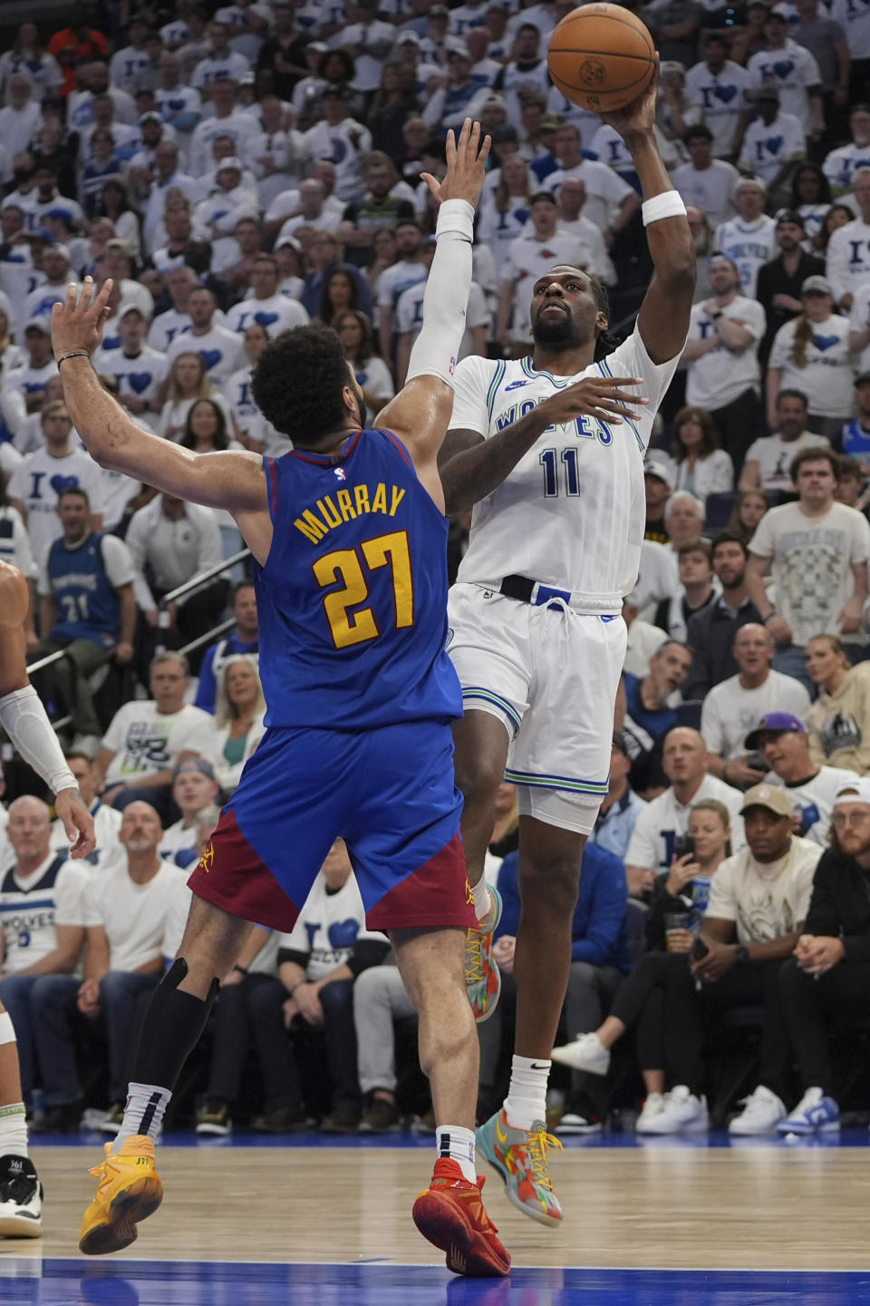 Minnesota Timberwolves center Naz Reid (11) shoots over Denver Nuggets guard Jamal Murray (27) during the second half of Game 6 of an NBA basketball second-round playoff series Thursday, May 16, 2024, in Minneapolis. (AP Photo/Abbie Parr)