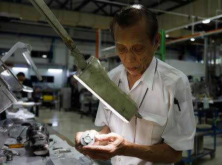 Mohamad Mohsin Khan, 74, assembles aircraft parts at ACE Services in Singapore December 17, 2018. REUTERS/Edgar Su/Files