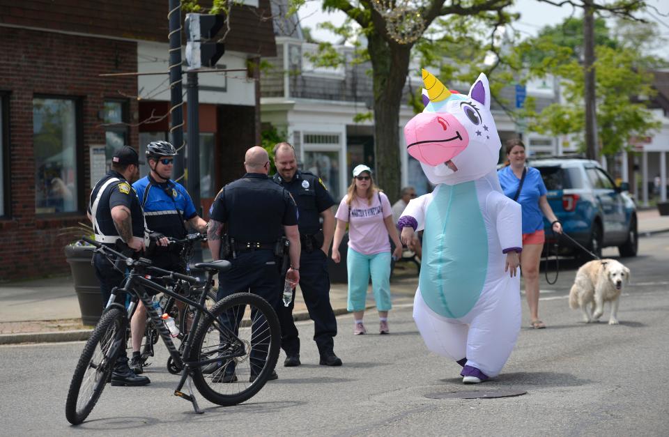 Eliza Bundschuh walks down Main Street in a unicorn costume. Hyannis Open Streets was held Sunday. A section of Main Street was closed to car traffic to make way for pedestrians. Vendors were set up throughout.
