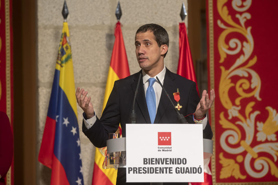 The leader of Venezuela's political opposition Juan Guaido makes a speech at the Madrid regional government building during a visit to Madrid, Spain, Saturday, Jan. 25, 2020. Juan Guaido, the man who one year ago launched a bid to oust Venezuelan President Nicolas Maduro, arrived Saturday in Spain, where a thriving community of Venezuelans and a storm among Spanish political parties awaited him.(AP Photo/Paul White)