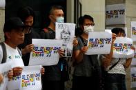 A demonstrator holds a poster of Simon Cheng, a staff member at the consulate who went missing on August 9 after visiting the neighbouring mainland city of Shenzhen, during a protest outside the British Consulate-general office in Hong Kong