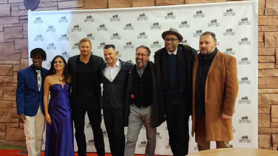 Members of the cast and crew of "What Remains" take a photo on the red carpet Thursday night at the Globe-News Center for the Performing Arts in downtown Amarillo.