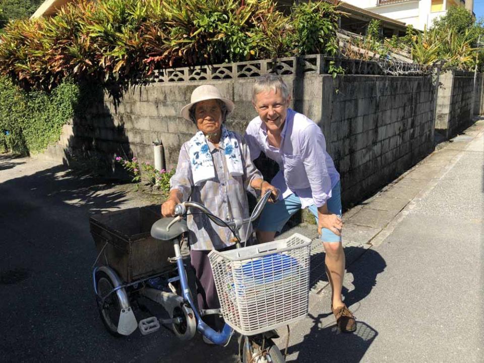 Chris in Okinawa with a 100-year-old woman. PA REAL LIFE