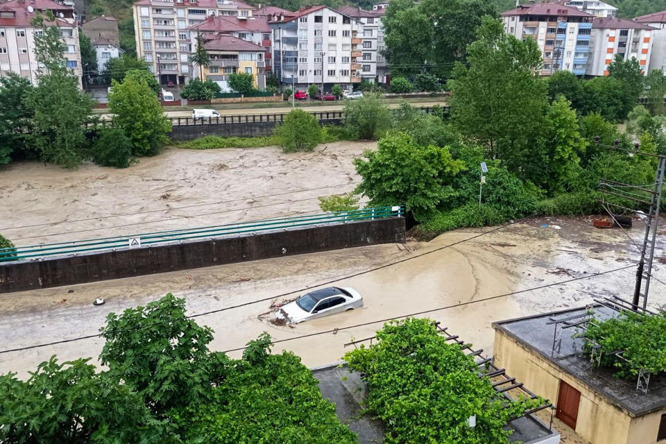 FILE - A partially submerged car is visible in floodwaters after heavy rains in Zonguldak, Turkey, July 10, 2023. Scientists say increasingly frequent and intense storms could unleash more rainfall in the future as the atmosphere warms and holds more moisture. (Dia Images via AP, File)