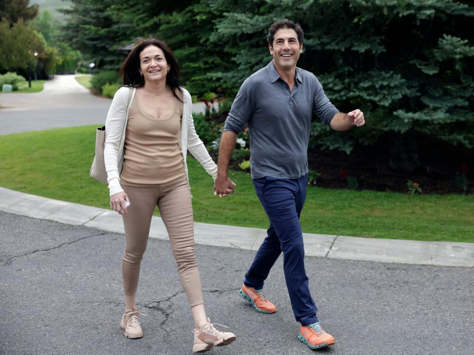 Meta COO Sheryl Sandberg holds hands with her fiancé at Sun Valley