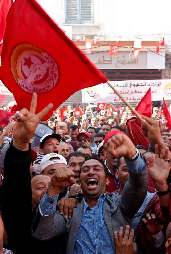 <p>Members of the Tunisian General Labor Union hold signs and wave flags during a rally to mark International Workers’ Day, or Labor Day, in Tunis, Tunisia, May 1, 2017. (Zoubeir Souissi/Reuters) </p>