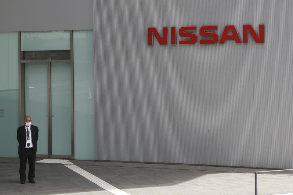 A man stands at Nissan Motor Co.'s global headquarters in Yokohama, near Tokyo, Tuesday, June 22, 2021. Nissan Chief Executive Makoto Uchida pleaded for patience from disgruntled shareholders Tuesday, promising a turnaround at the Japanese automaker, which is projecting a third year of losses as it struggles to distance itself from a scandal over its former Chairman Carlos Ghosn. (AP Photo/Koji Sasahara)