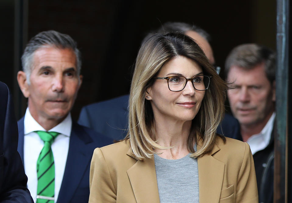  Actress Lori Loughlin and her husband Mossimo Giannulli, wearing green tie, leave the John Joseph Moakley United States Courthouse in Boston on April 3, 2019.