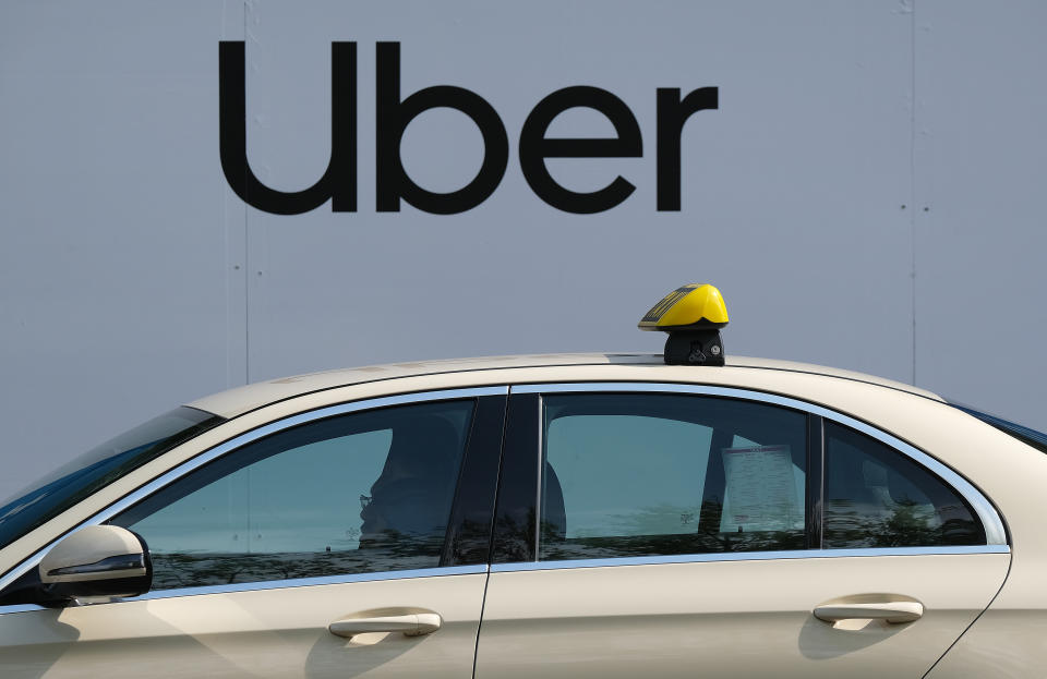 BERLIN, GERMANY - JUNE 1: A taxi stands parked next to a billboard advertisement for Uber, the U.S.-based ride-hailing, food delivery and bicycle-sharing company, on June 1, 2019 in Berlin, Germany. Uber recently launched an initial public offering on Wall Street.  (Photo by Sean Gallup/Getty Images)