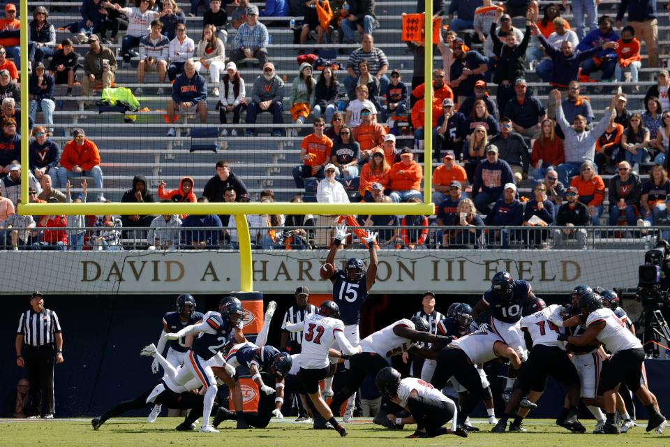 Oct 8, 2022; Charlottesville, Virginia, USA; Louisville Cardinals kicker James Turner (32) kicks a field goal as Virginia Cavaliers wide receiver Devin Chandler (15) attempts the block at the end of the second quarter at Scott Stadium. Mandatory Credit: Geoff Burke-USA TODAY Sports