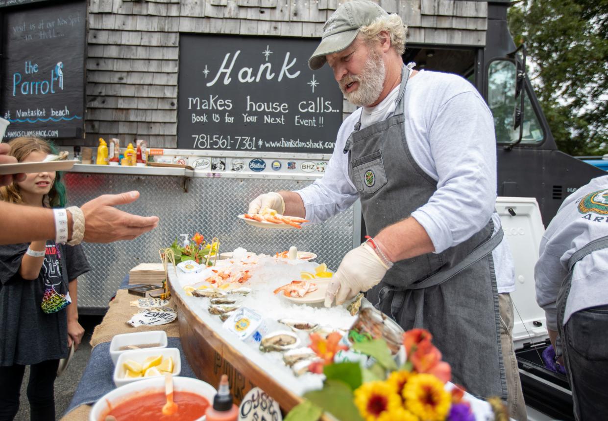Joby Norton, of Scituate-based Mullaney's Fish Market, serves shrimp at the Mad Love Festival in Hingham on Oct. 10, 2021.