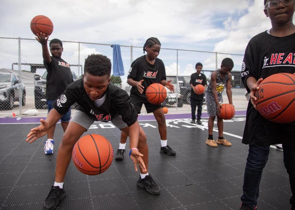 Children try out basketball tricks during a youth basketball clinic hosted by Rolling Loud and the Miami HEAT at the Rolling Loud basketball court outside Hard Rock Stadium in Miami Gardens, Fla., on Wednesday, July 19, 2023.