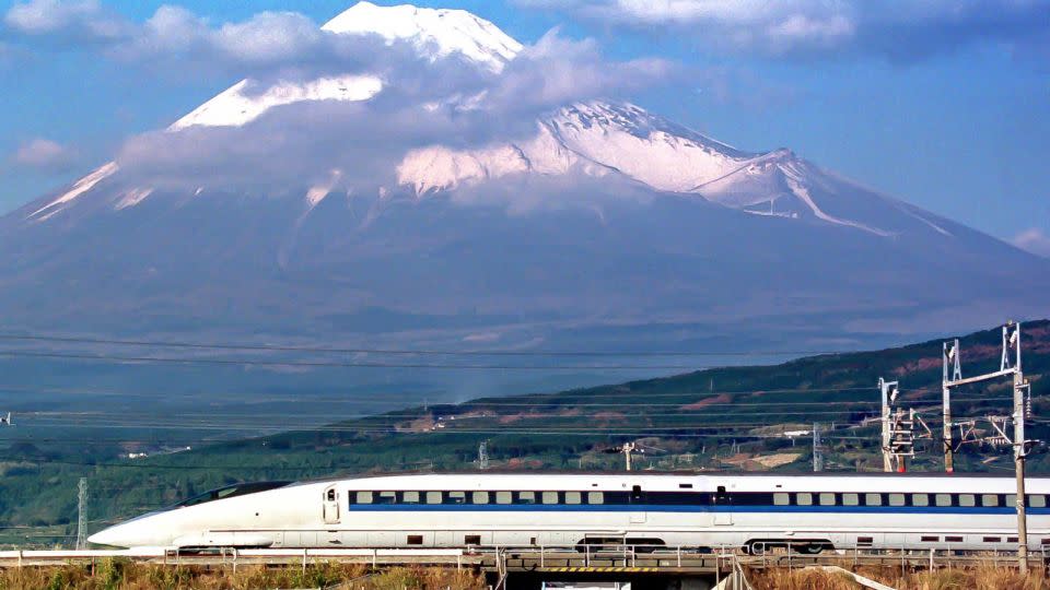 A Shinkansen train speeds past Mount Fuji. - AFP/Getty Images