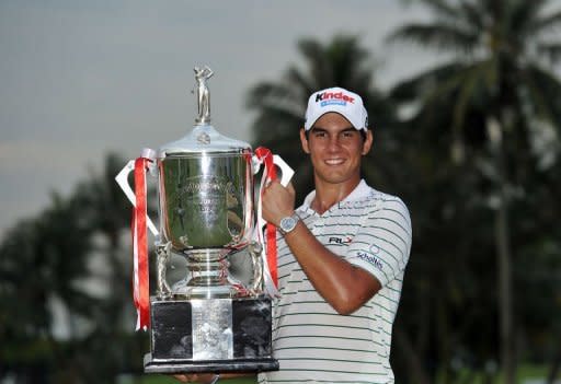 Matteo Manassero of Italy poses with the winner's trophy on day four of the Singapore Open at the Sentosa Golf Club in Singapore, in a handout photo provided by World Sport Group on November 11, 2012. Manassero holed a 12-foot eagle putt on the third play-off hole to claim a dramatic victory over South Africa's Louis Oosthuizen at the Singapore Open on Sunday