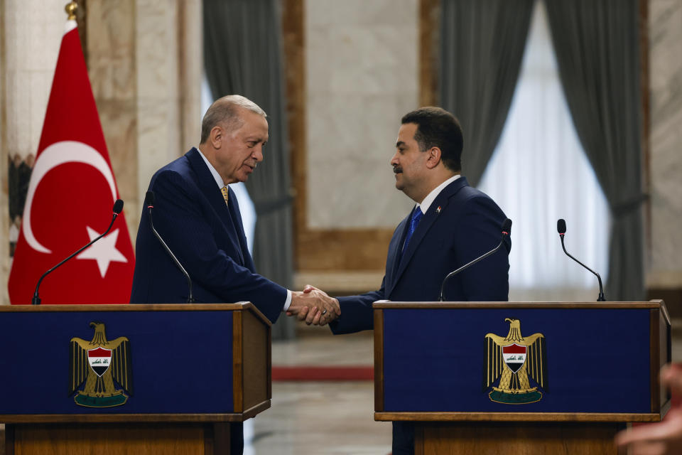 Turkish President Recep Tayyip Erdogan, left and Iraqi Prime Minister Mohammed Shia al-Sudani shake hands as they attend a press conference, in Baghdad, Iraq, Monday, April 22, 2024. Erdogan arrived in Iraq on Monday for his first official visit in more than a decade. (Thaier Al-Sudani/Pool Photo via AP)