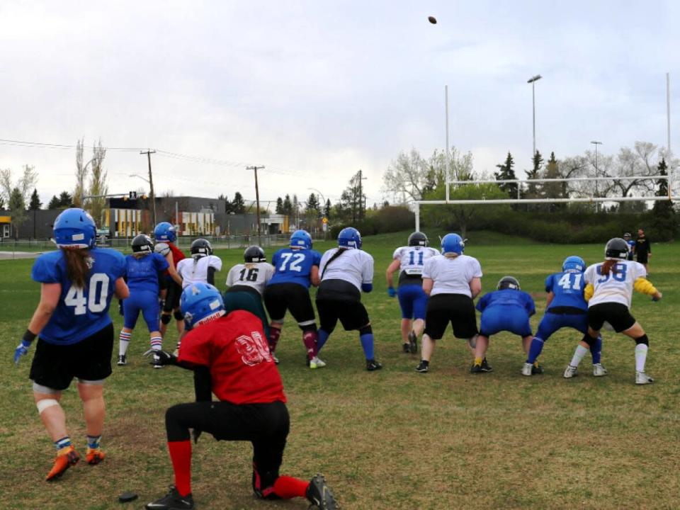 The Edmonton Storm practice on the field west of Jasper Place High School on March 17, 2022. The team is Edmonton’s only women’s tackle football team, and one of seven teams in the Women's Western Canadian Football League. (Clare Bonnyman/CBC - image credit)