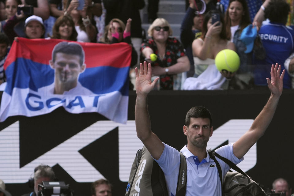 Novak Djokovic of Serbia gestures to the crowd as he leaves Rod Laver Arena following his loss to Jannik Sinner of Italy in their semifinal at the Australian Open tennis championships at Melbourne Park, Melbourne, Australia, Friday, Jan. 26, 2024. (AP Photo/Andy Wong)