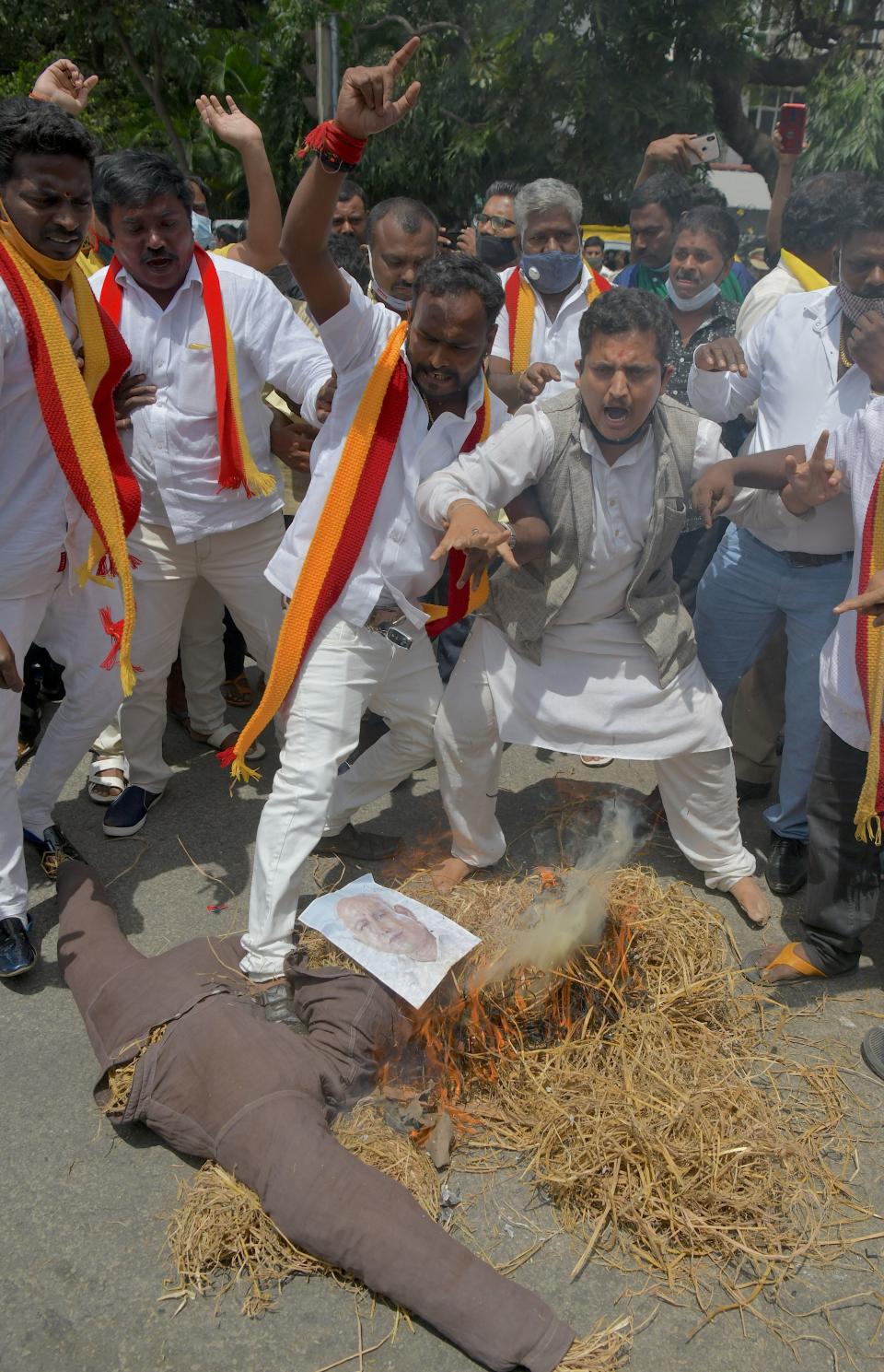 Activists belonging to various farmers rights organisations burn the effigy of Karnataka Chief Minister B. S. Yediyurappa during an anti-government demonstration to protest against the recent passing of new farm bills in parliament, in Bangalore on September 28, 2020. (Photo by Manjunath Kiran / AFP) (Photo by MANJUNATH KIRAN/AFP via Getty Images)